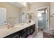 Bathroom featuring dual sinks, a large mirror and ample counter space at 26036 N 85Th Dr, Peoria, AZ 85383