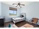 Sunny bedroom with a comfortable bed and desk area with exterior views at 26036 N 85Th Dr, Peoria, AZ 85383