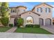 Elegant two-story home featuring a circular tower, arched entryway, dark shutters and a manicured lawn at 26036 N 85Th Dr, Peoria, AZ 85383