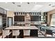Gourmet kitchen with marble countertops, stainless steel appliances, and seating at the island at 26036 N 85Th Dr, Peoria, AZ 85383