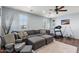 Cozy living room with large sectional, exercise equipment, and natural light from multiple windows at 26036 N 85Th Dr, Peoria, AZ 85383