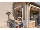 Covered outdoor kitchen with bar seating, heater, and stone accents, perfect for entertaining in style at 26036 N 85Th Dr, Peoria, AZ 85383