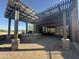 Stylish pergola-covered patio with stone accents, offering a shaded area for dining and socializing at 26036 N 85Th Dr, Peoria, AZ 85383