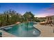 Beautiful pool area with a built-in spa, water feature, and fire features for ultimate relaxation and entertainment at 26036 N 85Th Dr, Peoria, AZ 85383