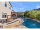 Backyard oasis features a pool and a patio with a porch swing at 26036 N 85Th Dr, Peoria, AZ 85383
