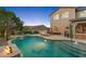 Stunning backyard with a sparkling pool, spa, water feature, and cozy fire pit, creating a resort-like atmosphere at 26036 N 85Th Dr, Peoria, AZ 85383