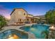 Backyard oasis featuring a large pool, covered patio, built-in fire pit, mountain views and lush landscaping at 26036 N 85Th Dr, Peoria, AZ 85383