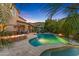 Backyard oasis featuring a large pool, covered patio, built-in fire pit, mountain views and lush landscaping at 26036 N 85Th Dr, Peoria, AZ 85383