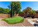 Backyard oasis featuring a putting green, fire pit, and comfortable seating area at 2759 E Balsam Dr, Chandler, AZ 85286