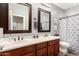 Bathroom with double sinks, framed mirrors and wood cabinets providing ample storage space at 2759 E Balsam Dr, Chandler, AZ 85286