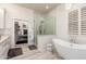 Bright bathroom featuring a walk-in shower, a soaking tub and a vanity with an adjacent walk-in closet at 2759 E Balsam Dr, Chandler, AZ 85286