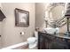 Chic powder room features decorative mirror, vessel sink, and dark wood vanity at 2759 E Balsam Dr, Chandler, AZ 85286