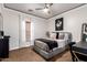Cozy bedroom featuring a dresser, vanity, window with white curtains, ceiling fan, and dark carpet at 2759 E Balsam Dr, Chandler, AZ 85286