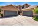 Exterior view of a home with a three-car garage, inviting entrance, and well-maintained landscaping at 2759 E Balsam Dr, Chandler, AZ 85286