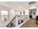 Upper hallway features wood and iron banister, windows, and recessed lighting at 2759 E Balsam Dr, Chandler, AZ 85286