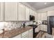 Well-lit kitchen features modern appliances, decorative backsplash, and ample counter space at 2759 E Balsam Dr, Chandler, AZ 85286