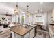 Bright and open kitchen with granite counters, island with sink, and adjacent dining area at 2759 E Balsam Dr, Chandler, AZ 85286