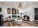 Bright living room featuring wood-look floors, elegant furnishings, and a decorative chandelier at 2759 E Balsam Dr, Chandler, AZ 85286