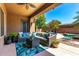 Comfortable covered patio with relaxing seating area overlooking lush backyard and pool at 2759 E Balsam Dr, Chandler, AZ 85286