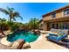 Inviting backyard pool with rock features, lush landscaping, and comfortable lounge seating at 2759 E Balsam Dr, Chandler, AZ 85286