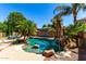 Beautiful pool area with tropical landscaping, rock waterfall, and clear turquoise water at 2759 E Balsam Dr, Chandler, AZ 85286