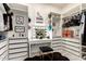 Walk-in closet with custom shelves, drawers, illuminated vanity mirror, and a cushioned stool at 2759 E Balsam Dr, Chandler, AZ 85286