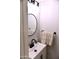 Elegant bathroom featuring a round mirror, modern faucet, and decorative patterned towels at 286 W Palomino Dr # 78, Chandler, AZ 85225