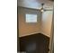 A compact bedroom offers natural light, dark wood floors, and a ceiling fan for added comfort at 286 W Palomino Dr # 78, Chandler, AZ 85225