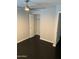 Bright bedroom with closet, ceiling fan, and dark wood floors at 286 W Palomino Dr # 78, Chandler, AZ 85225
