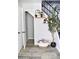 Stylish entryway with storage, decorative shelves, and a staircase with sleek black railings at 286 W Palomino Dr # 78, Chandler, AZ 85225