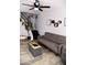 Inviting living room featuring a stylish gray sofa, modern decor, and sleek black staircase at 286 W Palomino Dr # 78, Chandler, AZ 85225