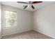 Bright bedroom with neutral carpet, ceiling fan and a window allows natural light at 29151 N Lilly Ln, San Tan Valley, AZ 85143
