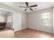 Clean and bright bedroom with tile floors, a ceiling fan, and a large window for natural light at 29151 N Lilly Ln, San Tan Valley, AZ 85143