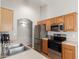 Functional kitchen with stainless steel appliances, oak cabinets, and ample counter space at 29151 N Lilly Ln, San Tan Valley, AZ 85143