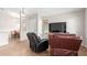 Spacious living area with large television and comfortable seating; perfect for entertaining and relaxation at 29151 N Lilly Ln, San Tan Valley, AZ 85143