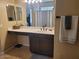 This is a well-lit bathroom with an accessible vanity and a towel rack with a gray towel at 2934 W Peggy Dr, San Tan Valley, AZ 85144