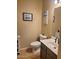 Neutral half bath with white toilet, framed artwork, white sink and vanity at 2934 W Peggy Dr, San Tan Valley, AZ 85144