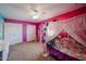Whimsical bedroom featuring bright walls, ceiling fan, closet, carpet, and a decorative draped canopy bed at 2934 W Peggy Dr, San Tan Valley, AZ 85144