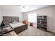 Bright bedroom features a large bed, ceiling fan, a shelving unit and neutral-colored walls at 2934 W Peggy Dr, San Tan Valley, AZ 85144