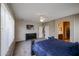 Spacious bedroom with a large bed, black dresser and an adjoining bathroom at 2934 W Peggy Dr, San Tan Valley, AZ 85144