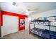 This is a fun bedroom with bunkbeds, red accent walls, and light colored carpet at 2934 W Peggy Dr, San Tan Valley, AZ 85144