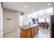 Open-concept kitchen with stainless steel appliances, wooden cabinets, and adjacent dining area with bright windows at 2934 W Peggy Dr, San Tan Valley, AZ 85144