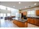 Bright kitchen features wooden cabinets, stainless steel appliances, and an island with countertop seating at 2934 W Peggy Dr, San Tan Valley, AZ 85144
