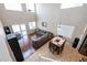 Open floor plan with soaring ceilings, hardwood floors, tiled floors, large gray sectional sofa, and dining set at 2934 W Peggy Dr, San Tan Valley, AZ 85144