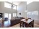 Inviting living area with high ceilings, wooden flooring, and plenty of natural light with adjacent dining area at 2934 W Peggy Dr, San Tan Valley, AZ 85144