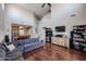 Spacious living room with high ceilings, hardwood floors, a cozy sectional, and view of the staircase at 2934 W Peggy Dr, San Tan Valley, AZ 85144