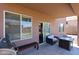 Covered patio with outdoor seating, BBQ grill, and easy access through sliding glass door at 2934 W Peggy Dr, San Tan Valley, AZ 85144