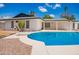 Large pool with diving board and home exterior nestled within a fenced backyard at 3008 S Saguaro Cir, Mesa, AZ 85202