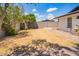 Backyard featuring dry lawn, concrete block fence, and small irrigation system at 3008 S Saguaro Cir, Mesa, AZ 85202