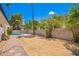 Large private backyard with palm trees, a refreshing pool, and block fence at 3008 S Saguaro Cir, Mesa, AZ 85202